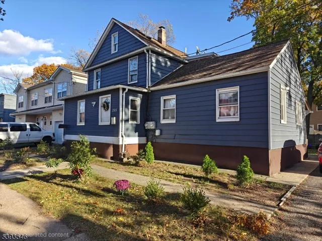 a view of a brick house with a yard