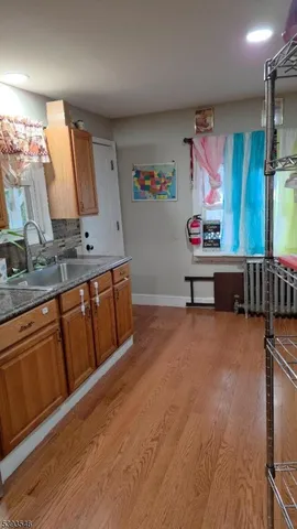 a kitchen with granite countertop a stove sink and cabinets