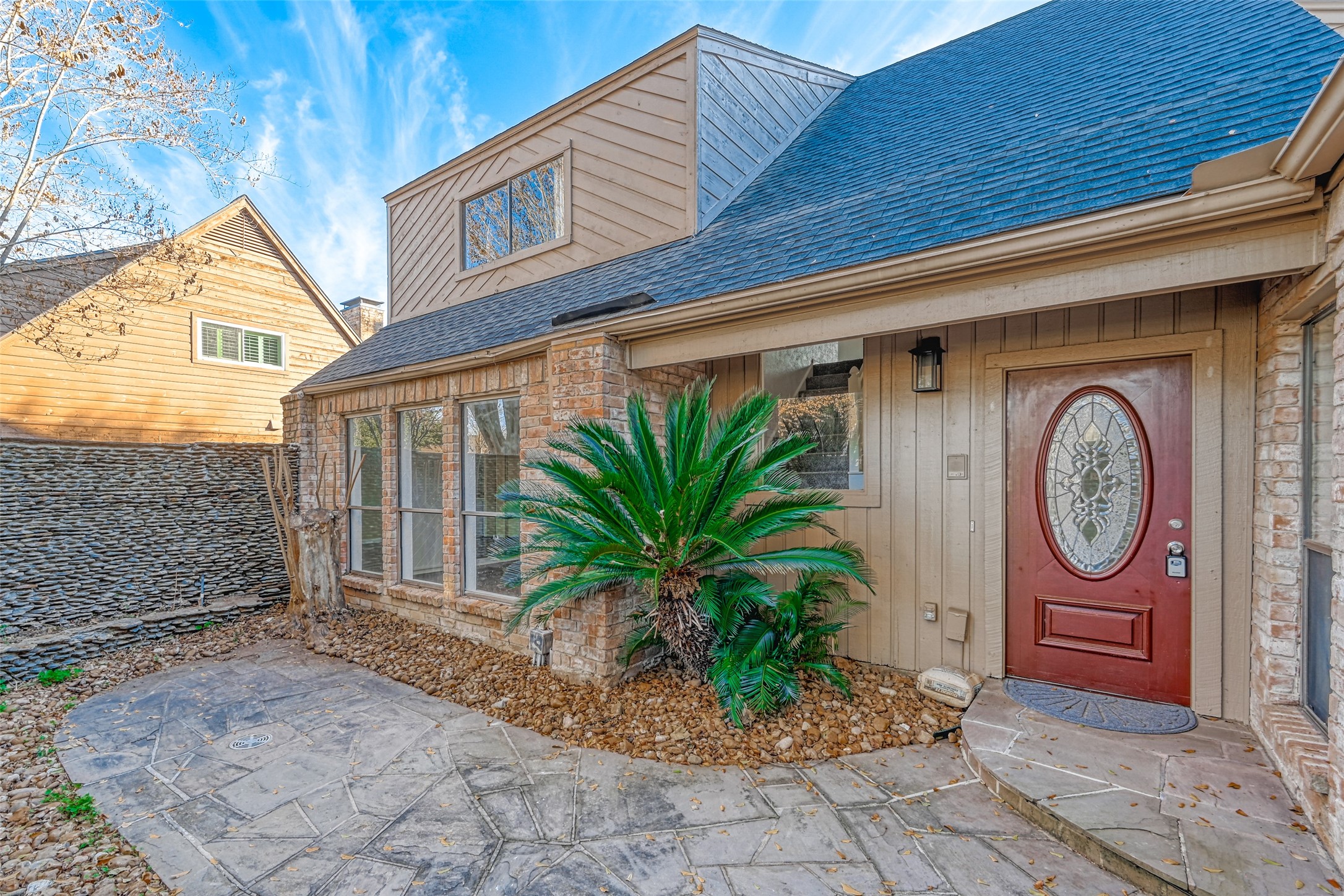 2107 Shadowbriar Drive Houston, TX 77077 - Photo 3 of 26 Stone adorned private wall in the enclosed front entry yard