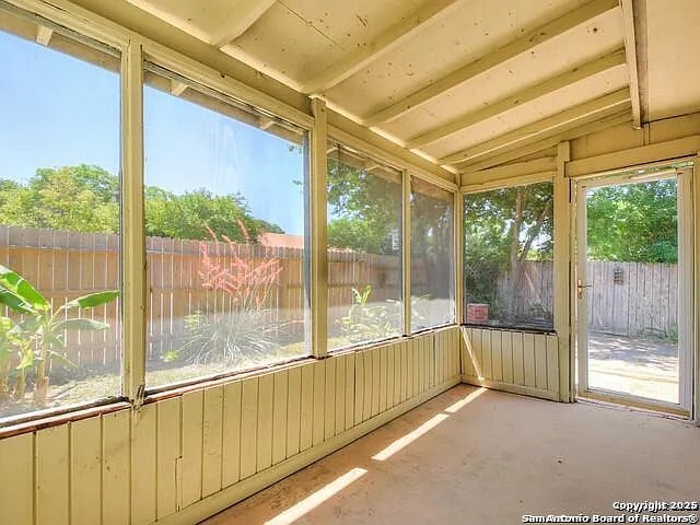 9502 Swans Crossing San Antonio, TX 78250 - Photo 13 of 17 a view of an empty room with wooden floor and a window
