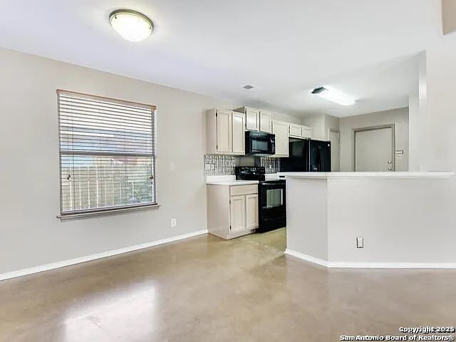 9502 Swans Crossing San Antonio, TX 78250 - Photo 3 of 17 a kitchen with stainless steel appliances a refrigerator sink and microwave