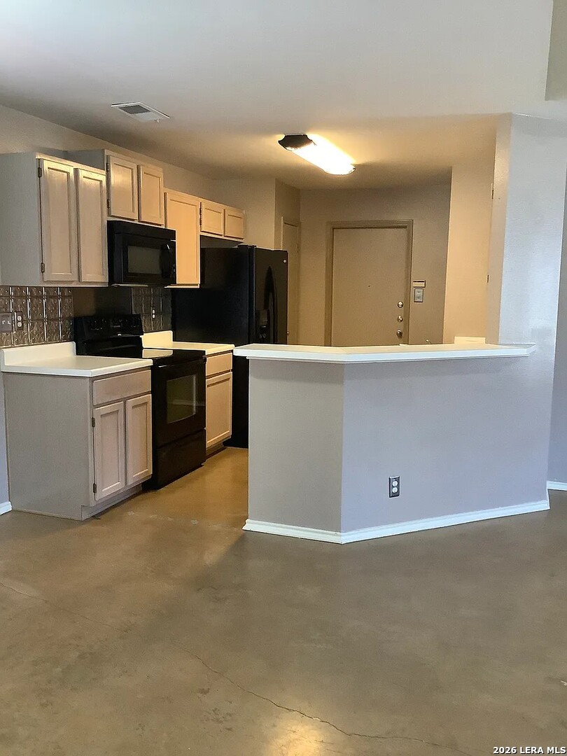 9502 Swans Crossing San Antonio, TX 78250 - Photo 6 of 17 a view of a kitchen with microwave and cabinets