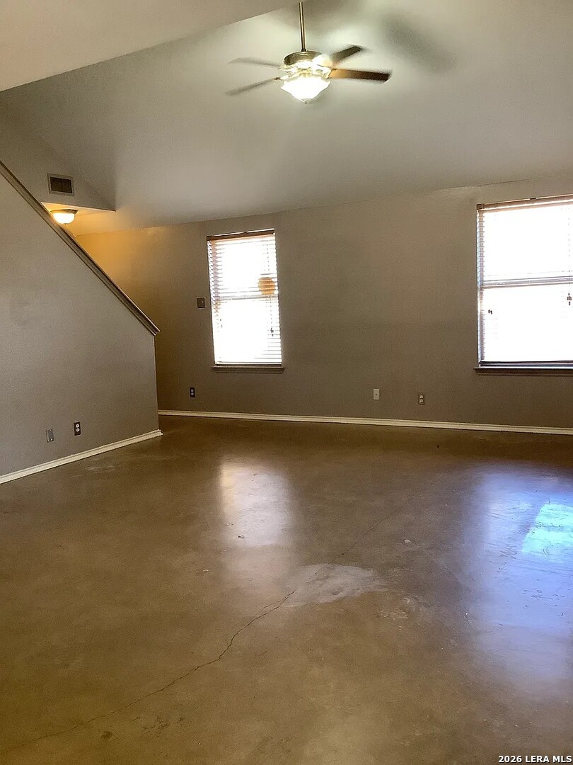 9502 Swans Crossing San Antonio, TX 78250 - Photo 7 of 17 an empty room with wooden floor and windows