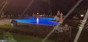 a kitchen with stainless steel appliances kitchen island granite countertop a refrigerator and a sink