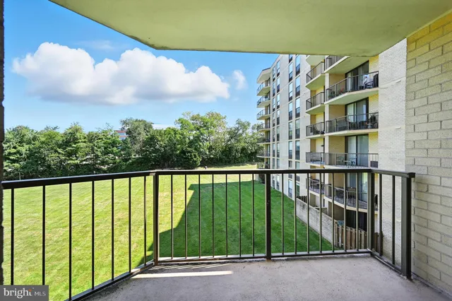 a living room with furniture and large windows