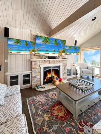 a living room with furniture a flat screen tv and a fireplace