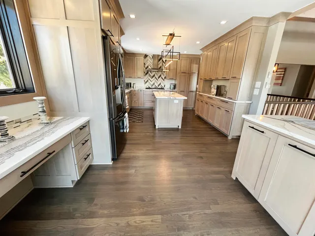 a kitchen with white cabinets and white appliances