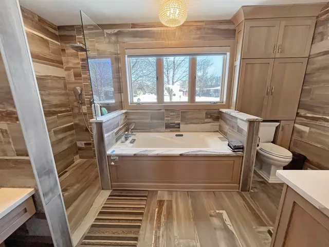 a spacious bathroom with a bathtub and shower