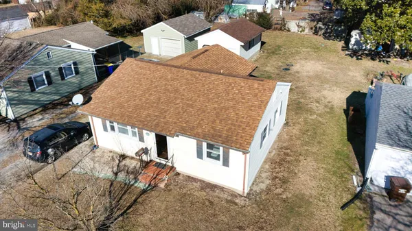 an aerial view of a house with large trees