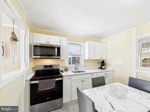 a kitchen with a sink stove and microwave