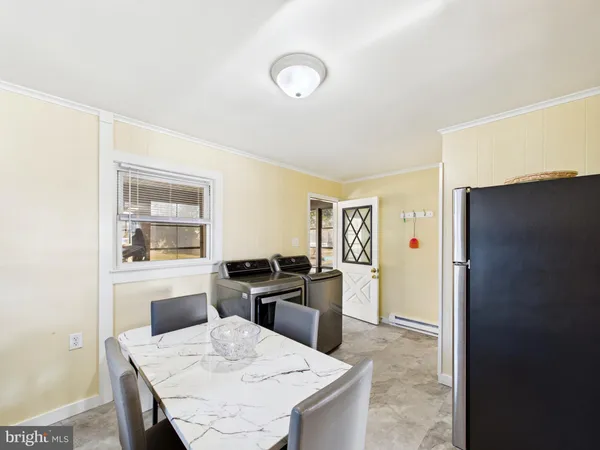 a kitchen with a table and refrigerator