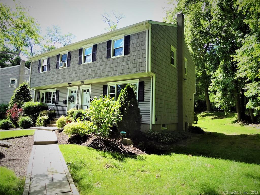 130 Rodgers Road, Unit 130 Fairfield, CT 06824 - Photo 1 of 1 a front view of a house with garden