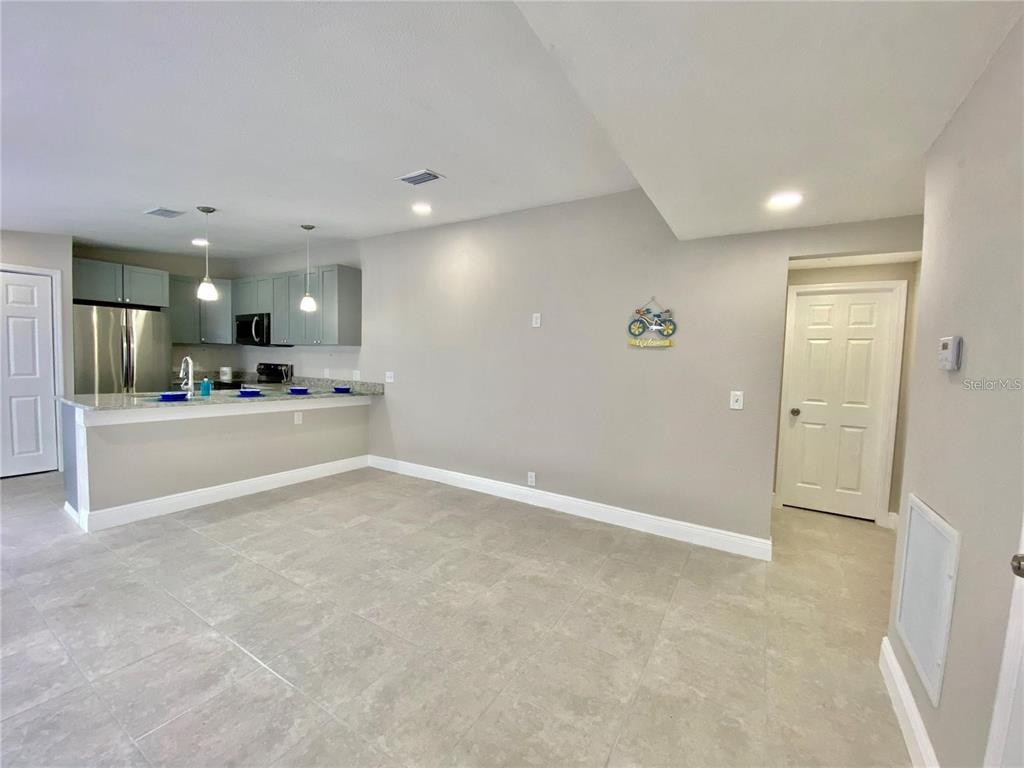 8726 Mayflower Road Tampa, FL 33615 - Photo 4 of 7 a view of a hallway with kitchen and kitchen island