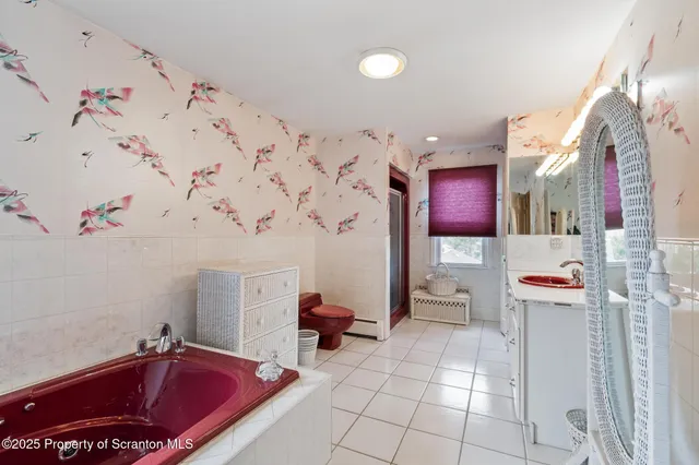 a bathroom with a sink vanity mirror and toilet