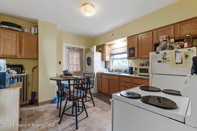 a view of a kitchen filled with furniture and a kitchen