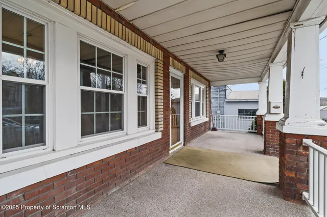 a view of an entryway with wooden floor and windows