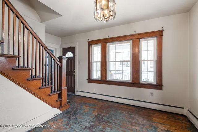 a view of an entryway with wooden floor