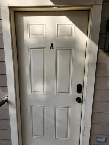 a kitchen with stainless steel appliances granite countertop a sink and a refrigerator