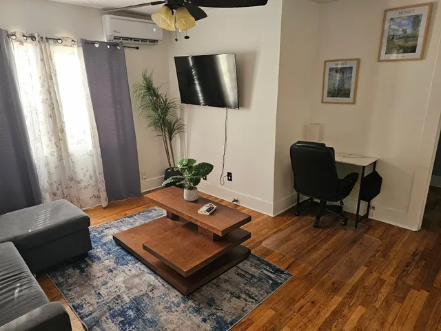 a living room with furniture and a rug
