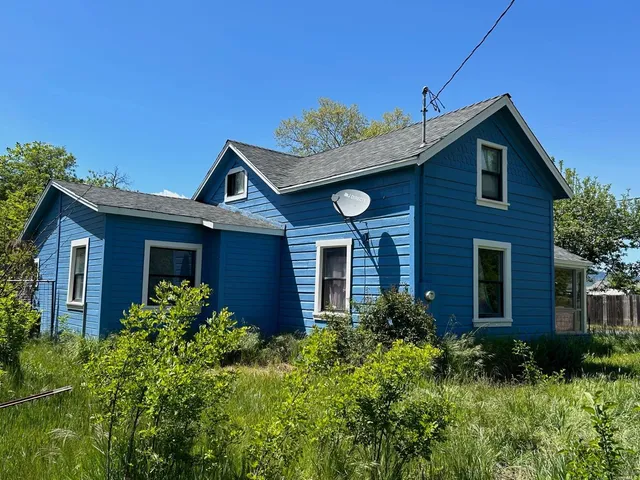 a view of a house with brick walls and potted plants