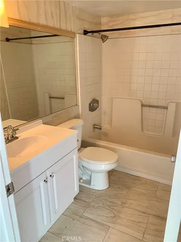 a bathroom with a toilet a sink and shower