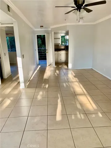 a view of a livingroom with wooden floor and a ceiling fan