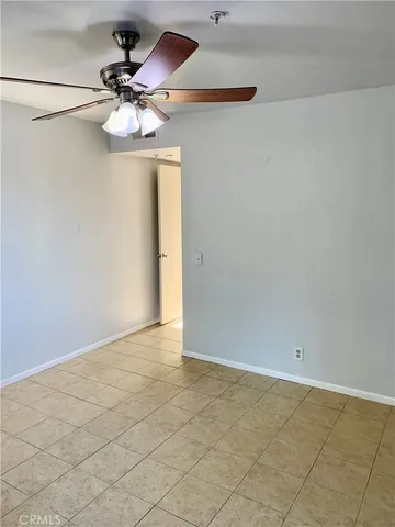a view of a chandelier fan and refrigerator