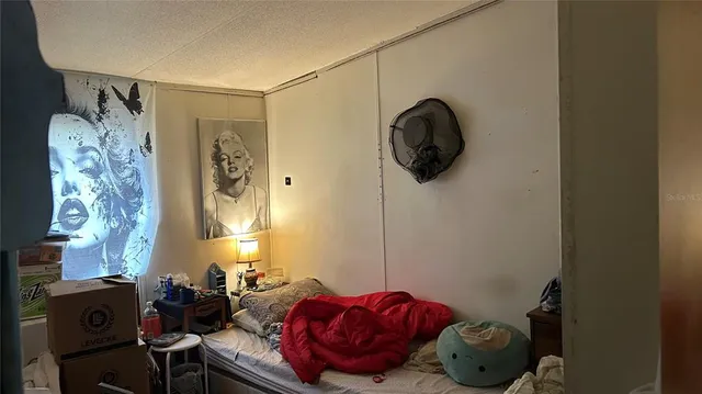 a bedroom with a bed and a chandelier