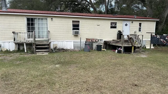 a view of a house with a yard and furniture