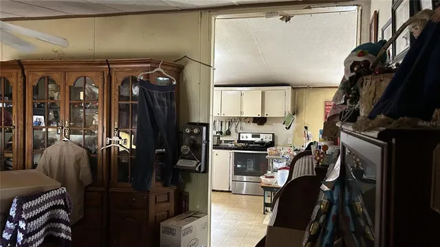 a kitchen with a refrigerator a stove top oven a sink and cabinets