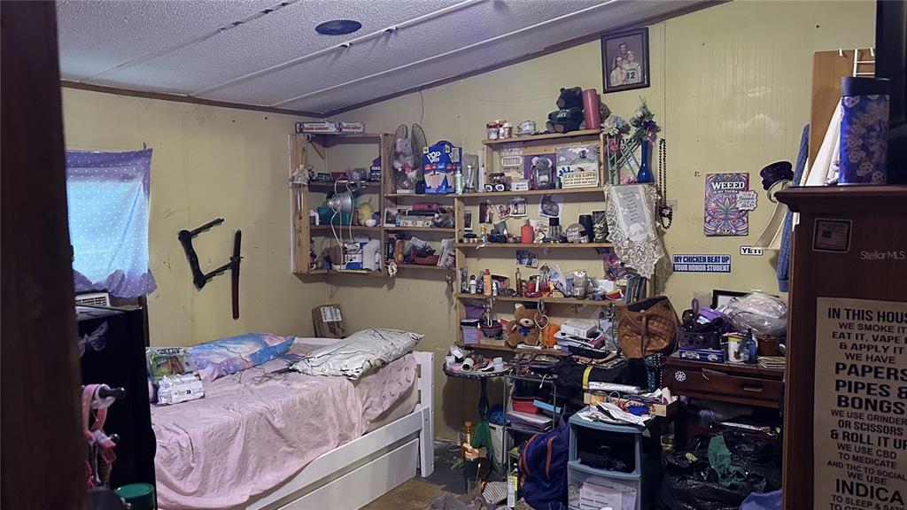 13752 Suwannee Boulevard O'Brien, FL 32071 - Photo 8 of 19 a bed room with a bed and a book shelf