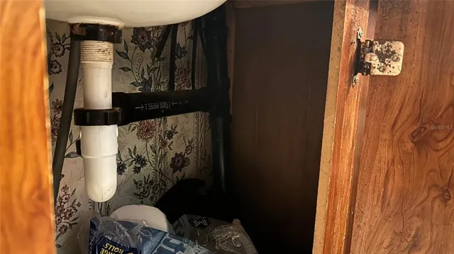 a bathroom with a toilet and a shower curtain