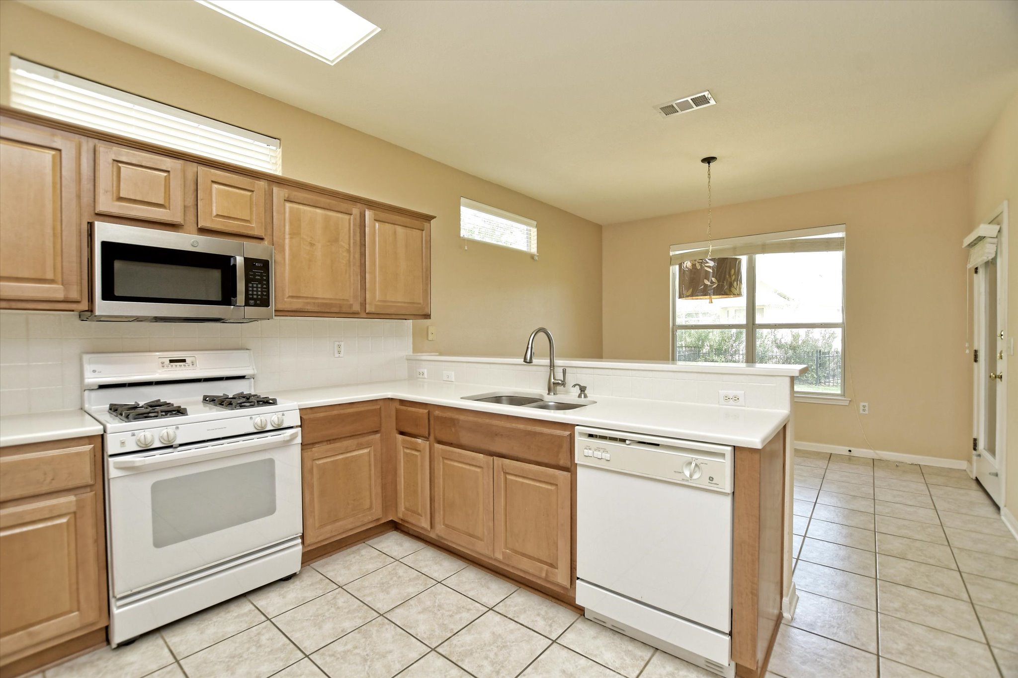 112 Bluebell Drive Georgetown, TX 78633 - Photo 16 of 23 a kitchen with a sink stove and microwave