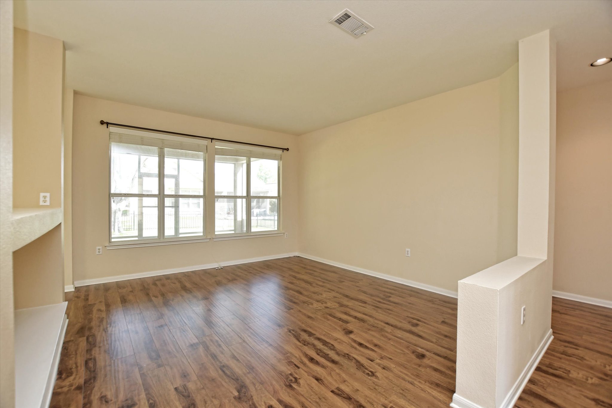 112 Bluebell Drive Georgetown, TX 78633 - Photo 6 of 23 a view of an empty room with wooden floor and a window
