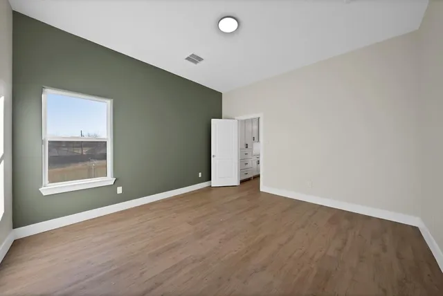 a bathroom with a toilet sink vanity and mirror