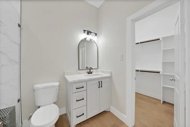 a bathroom with a sink toilet and shower
