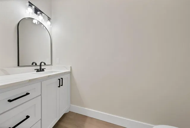 a bathroom with a double vanity sink mirror double and bathtub