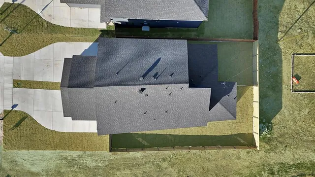 a kitchen with stainless steel appliances granite countertop a sink a stove a refrigerator and island with wooden floor