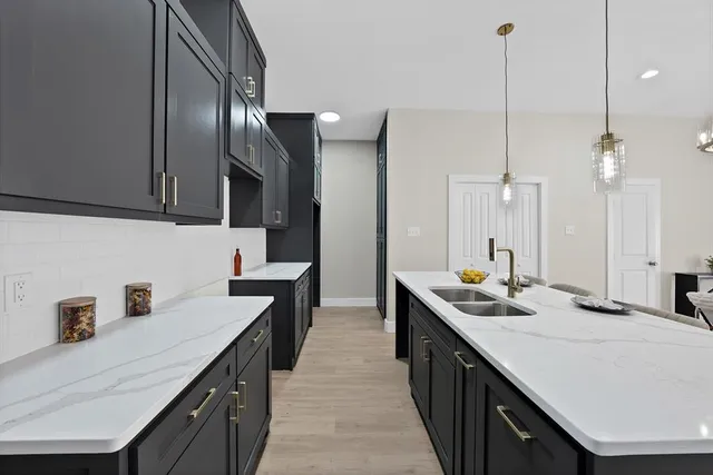 a living room with furniture and view of kitchen