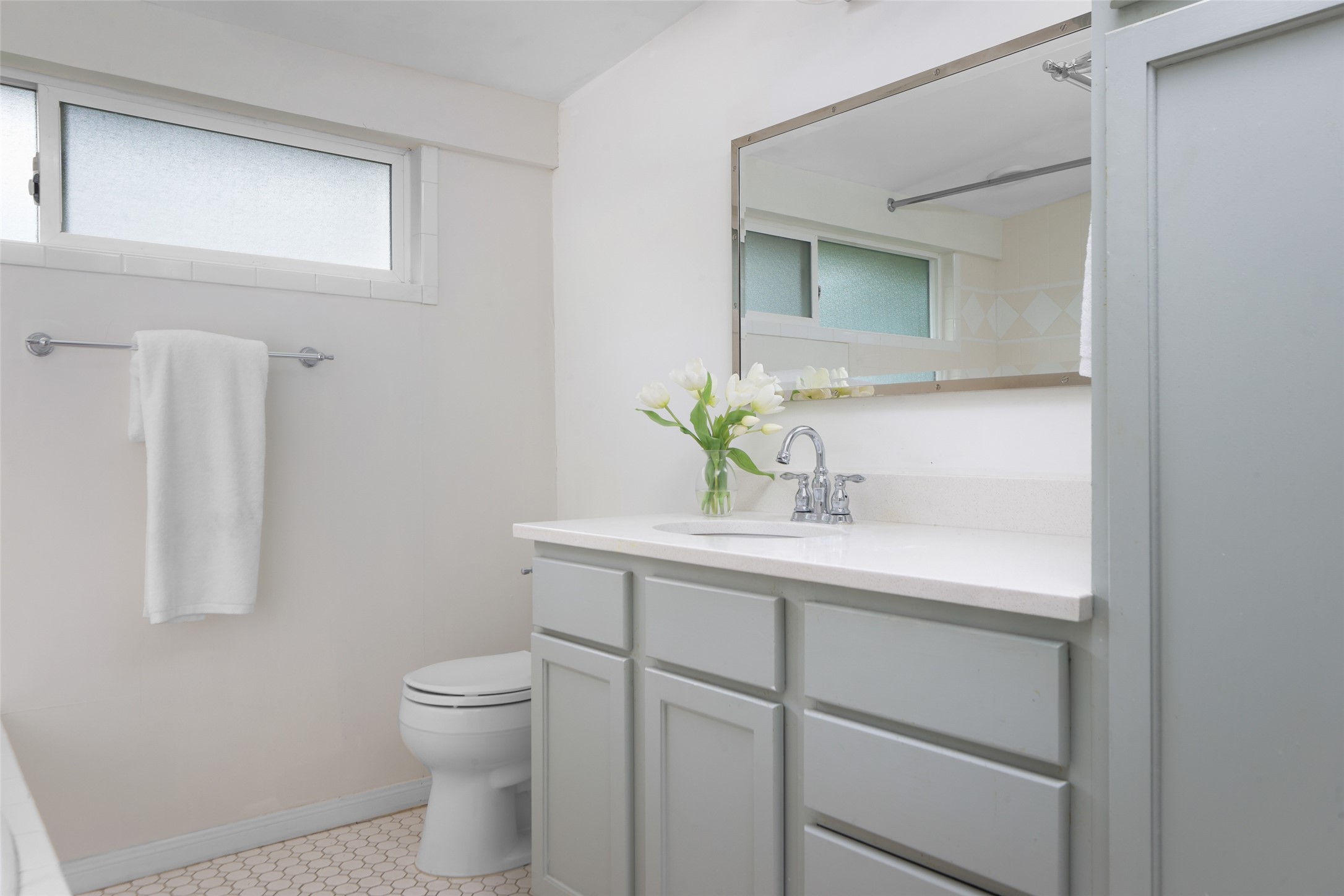 1917 Miles Avenue Austin, TX 78745 - Photo 19 of 39 a bathroom with a toilet sink and mirror