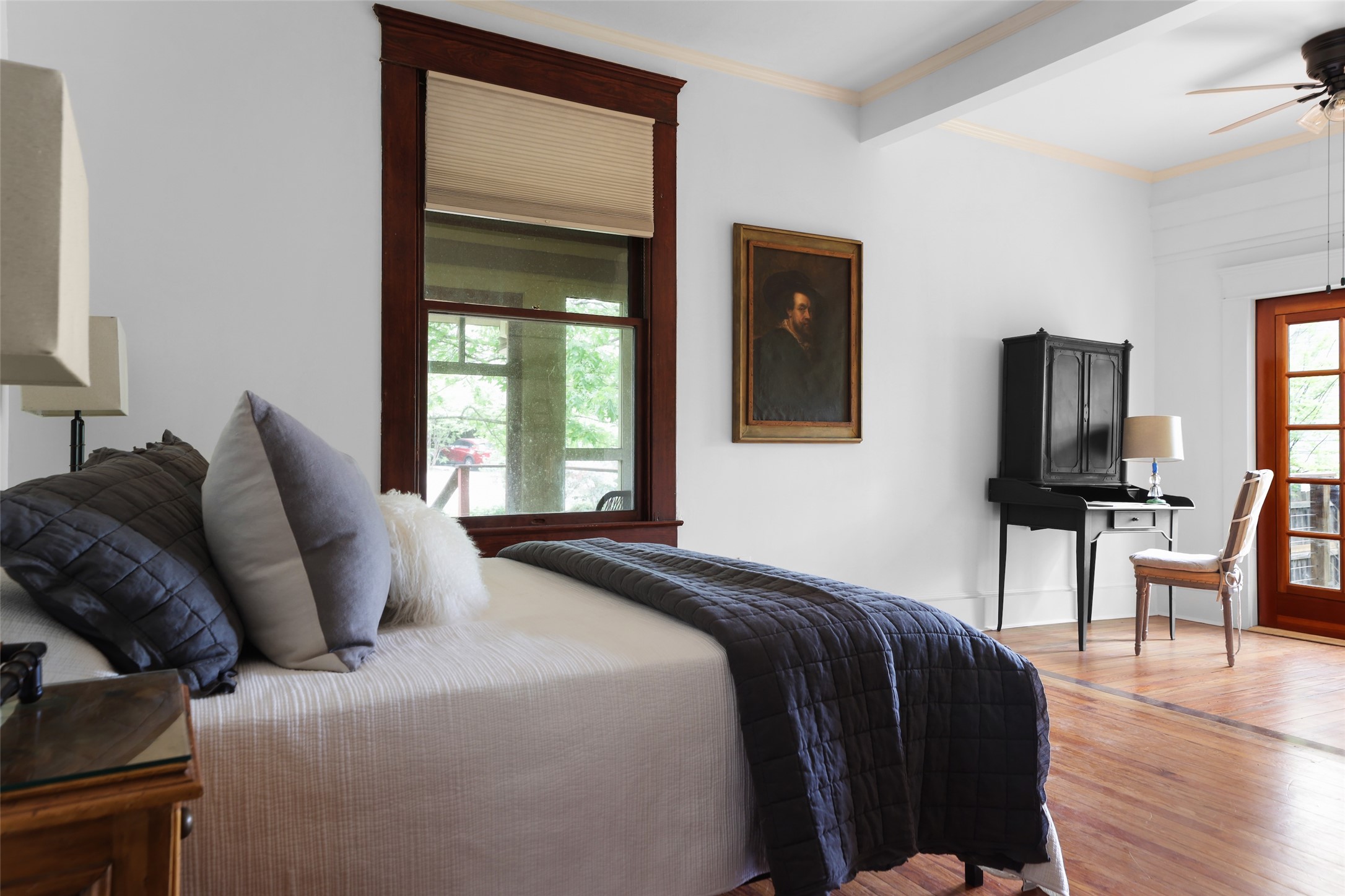 1917 Miles Avenue Austin, TX 78745 - Photo 20 of 39 a bedroom with a bed and wooden floor