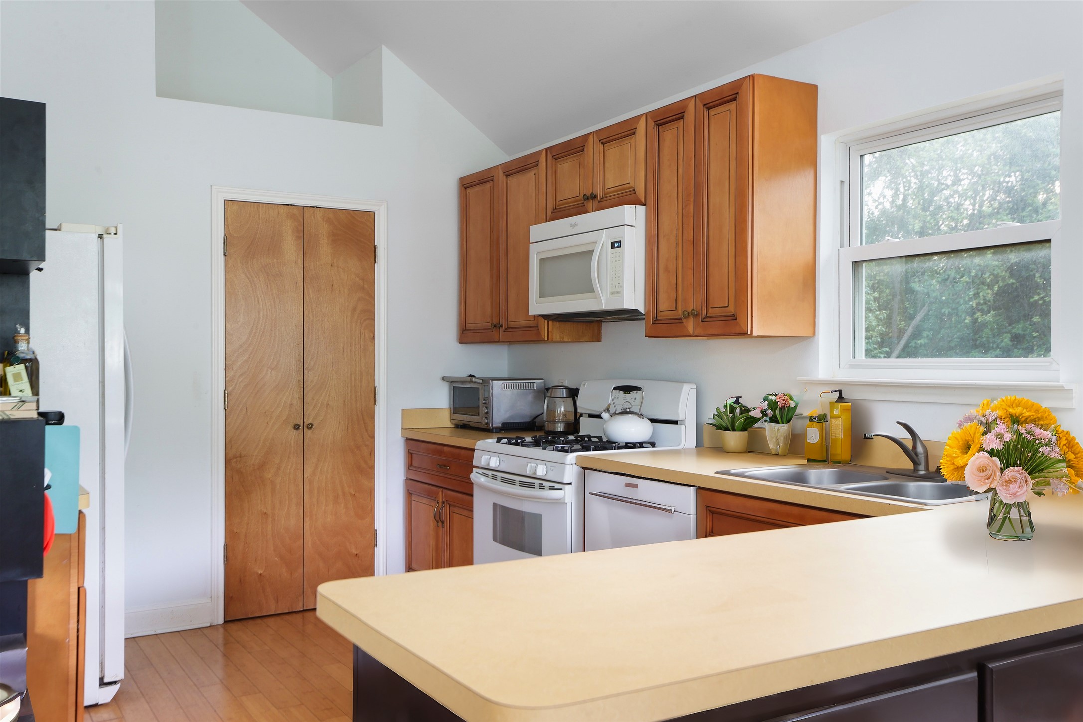 1917 Miles Avenue Austin, TX 78745 - Photo 25 of 39 a kitchen with stainless steel appliances a stove a sink cabinets and a window