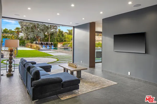 a living room with furniture and a painting