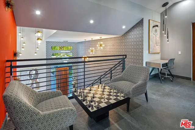 a bedroom with a bed and large window