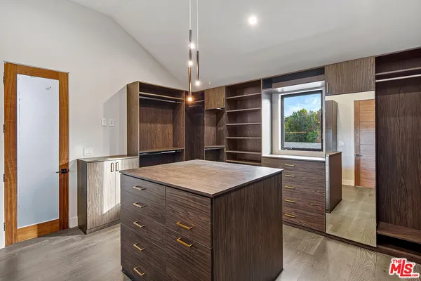 a kitchen with kitchen island a stove cabinets and wooden floor