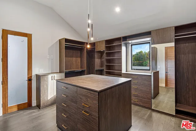 a kitchen with kitchen island a stove cabinets and wooden floor