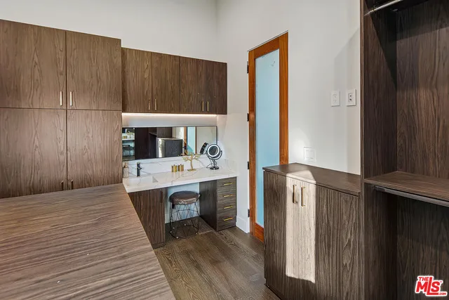a bedroom with a bed window and potted plant on the dresser