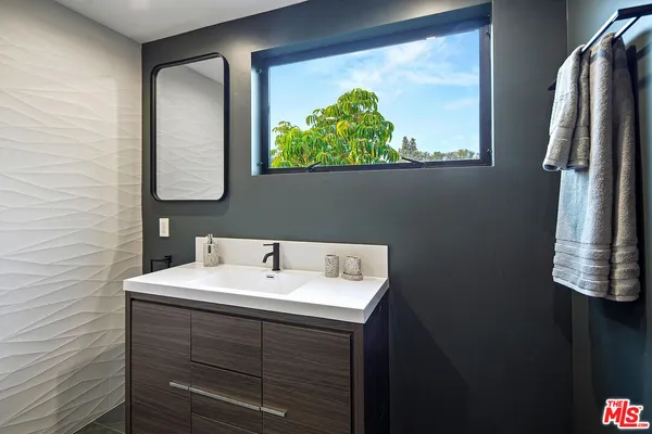 a room with lots of furniture and a large window