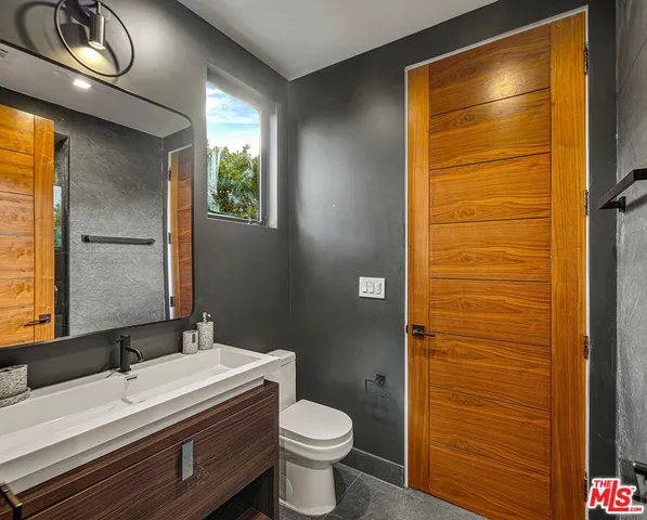 a living room with furniture a floor to ceiling window and a flat screen tv