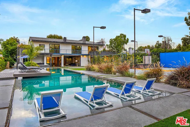 a view of a swimming pool with chairs